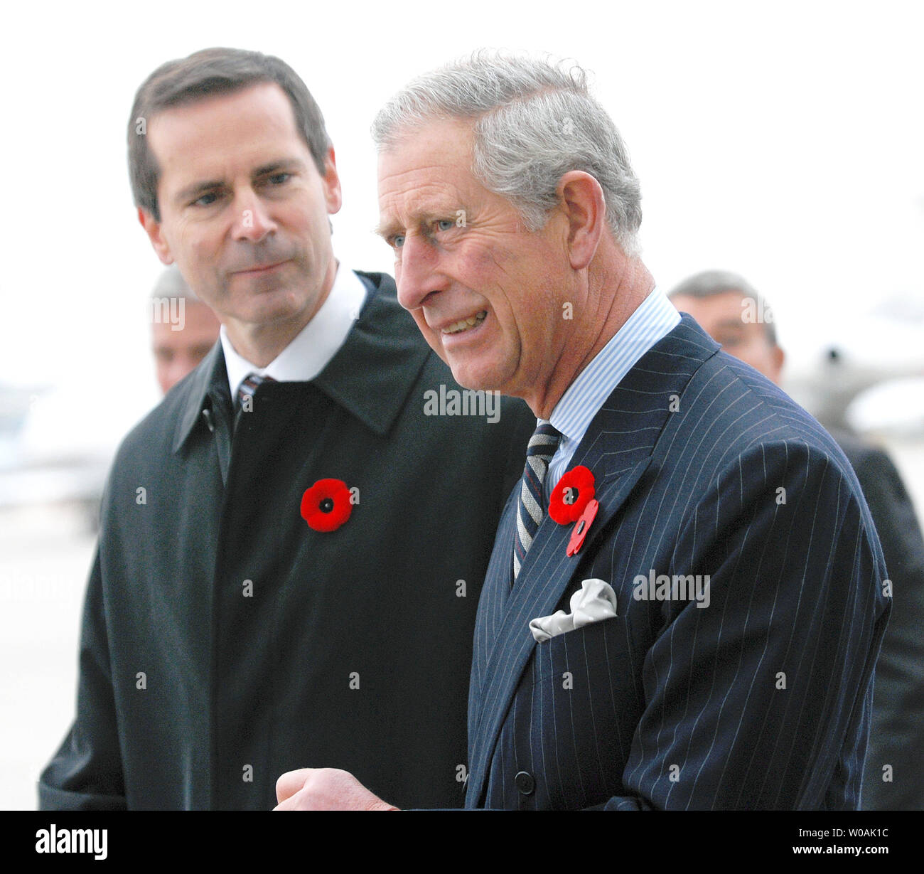Britain's Prince Charles (R) and Ontario premier Dalton McGuinty chat on the tarmac as the Prince and his wife Camilla, Duchess of Cornwall, arrive at Pearson International Airport in Toronto, Canada on November 4, 2009.  The royal couple are on an 11-day tour of Canada.  UPI /Christine Chew Stock Photo