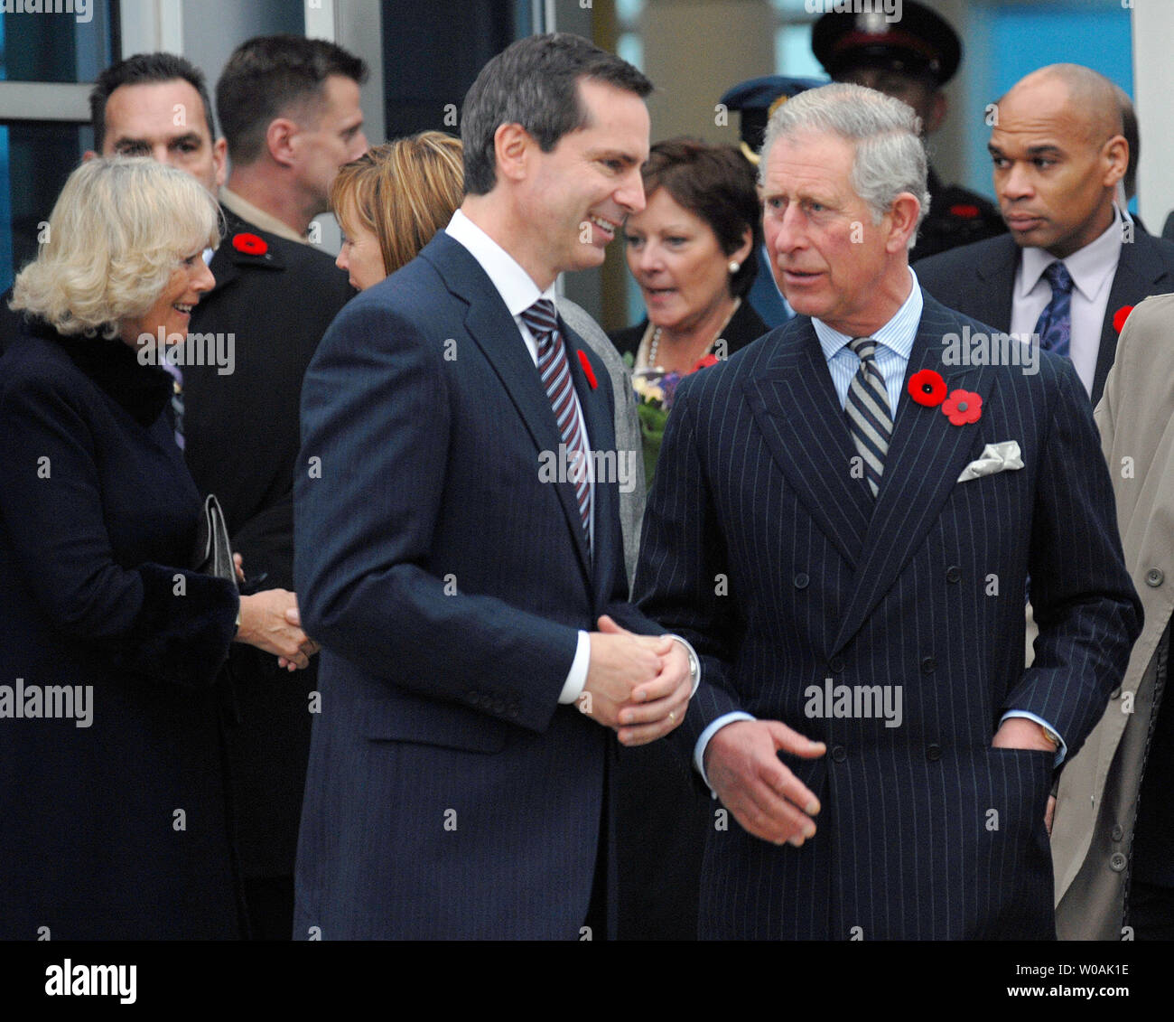 Britain's Prince Charles (R) and Ontario premier Dalton McGuinty chat as the Prince and his wife Camilla, Duchess of Cornwall (L), arrive at Pearson International Airport in Toronto, Canada on November 4, 2009.  The royal couple are on an 11-day tour of Canada.  UPI /Christine Chew Stock Photo