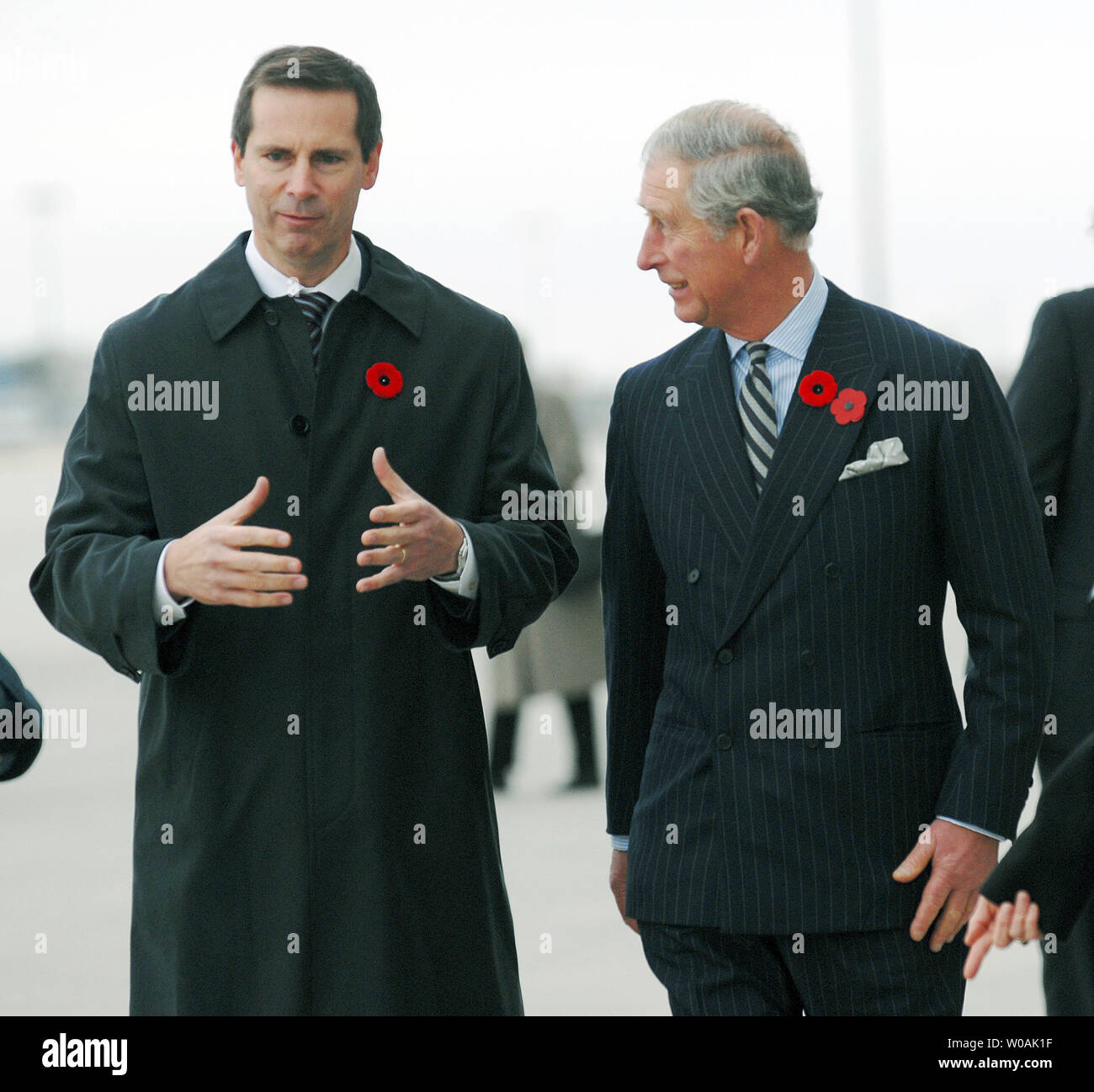 Britain's Prince Charles (R) and Ontario premier Dalton McGuinty chat on the tarmac as the Prince and his wife Camilla, Duchess of Cornwall, arrive at Pearson International Airport in Toronto, Canada on November 4, 2009.  The royal couple are on an 11-day tour of Canada.  UPI /Christine Chew Stock Photo