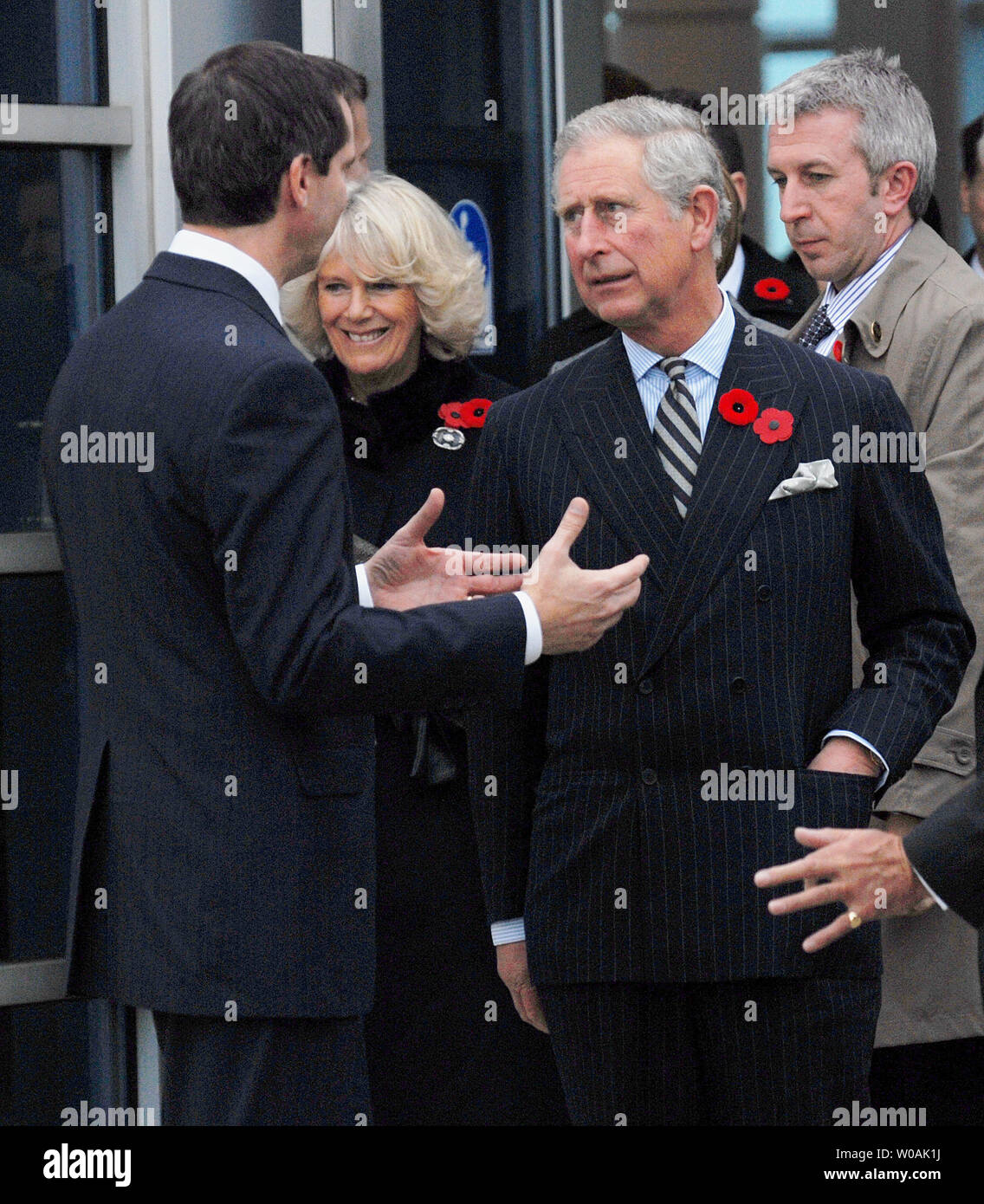 Britain's Prince Charles (R) and Ontario premier Dalton McGuinty chat as the Prince and his wife Camilla, Duchess of Cornwall (center), arrive at Pearson International Airport in Toronto, Canada on November 4, 2009.  The royal couple are on an 11-day tour of Canada.  UPI /Christine Chew Stock Photo