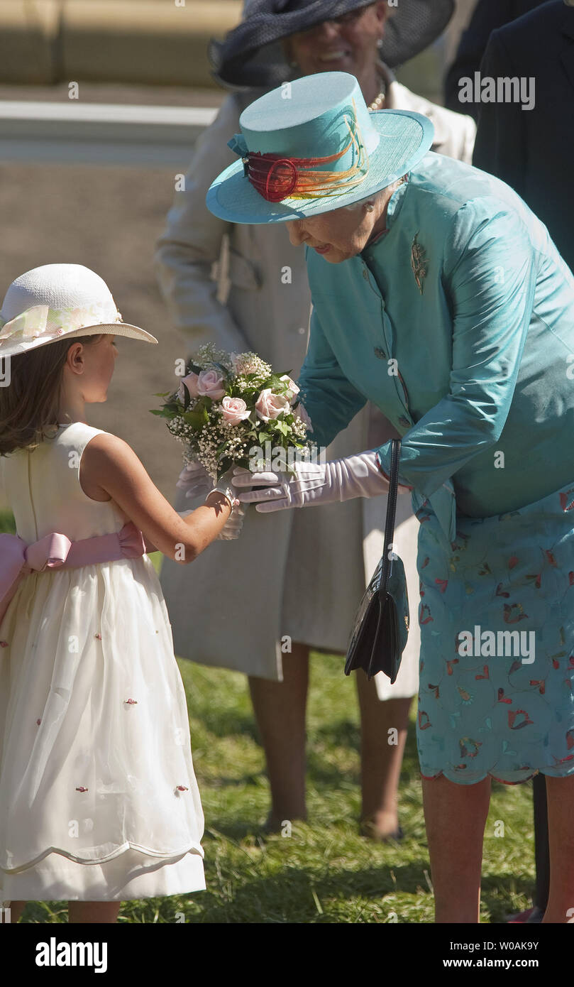 Great Britain's Queen Elizabeth receives flowers from 6-year-old Taylor Stezinar as she and Prince Philip walk to their royal box at Woodbine Racetrack for the Queen's Plate Stakes horse races at Woodbine Racetrack near Toronto, Ontario, July 4, 2010. The Queen and Prince Philip are on day seven of their nine day Royal Tour of Canada.  UPI/Heinz Ruckemann Stock Photo