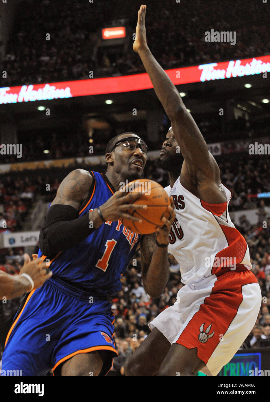 New York Knicks' Amar'e Stoudemire (L) drives into the key past  Toronto Raptors' Reggie Evans in second quarter action of the Raptors' home opener at the Air Canada Center in Toronto, Canada on October 27, 2010. The Knicks defeated the Raptors 98-93.   UPI /Christine Chew Stock Photo