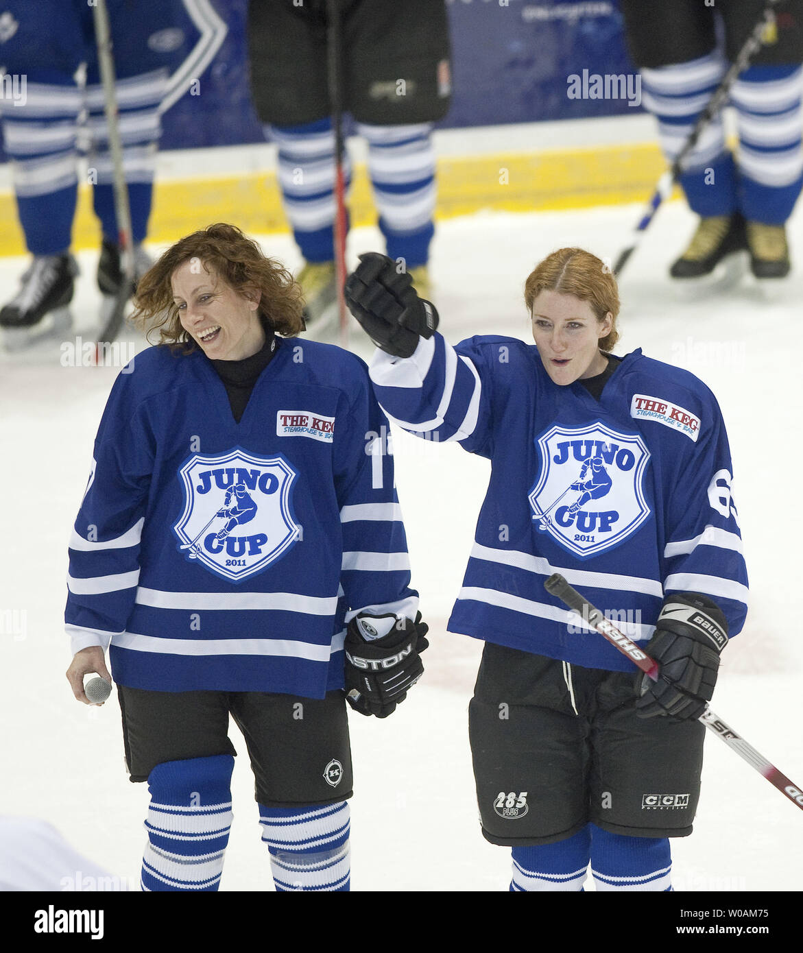 The Rockers Sarah Harmer (L) and Kathleen Edwards cheer at halftime of Juno Cup hockey against the NHL Greats at the Ricoh Center during the 2011 Juno Awards in Toronto, Ontario, March 25, 2011.   UPI Photo /Heinz Ruckemann Stock Photo