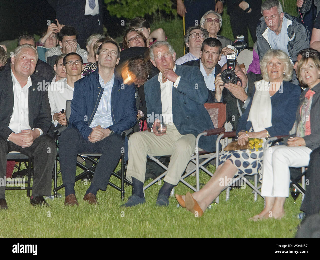 Prince Charles sits with his wife Camilla the Duchess of Cornwall, Ontario Premier Dalton McGuinty and Toronto Mayor Rob Ford (L) as they watch Victoria Day fireworks at Ashbridges Bay in Toronto, Ontario on May 21, 2012 after meeting members of the Ontario emergency services and their families during the second leg of their 2012 Royal Tour to Canada part of Queen Elizabeth's Diamond Jubilee celebrations.     UPI Photo /Heinz Ruckemann Stock Photo