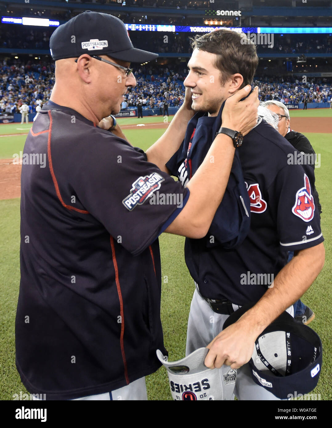 Cleveland Indians manager Terry Francona (L) hugs Indians game five  starting pitcher Ryan Merritt after winning the American League  Championship Series at Rogers Centre on October 19, 2016. Cleveland  defeated Toronto 3-0