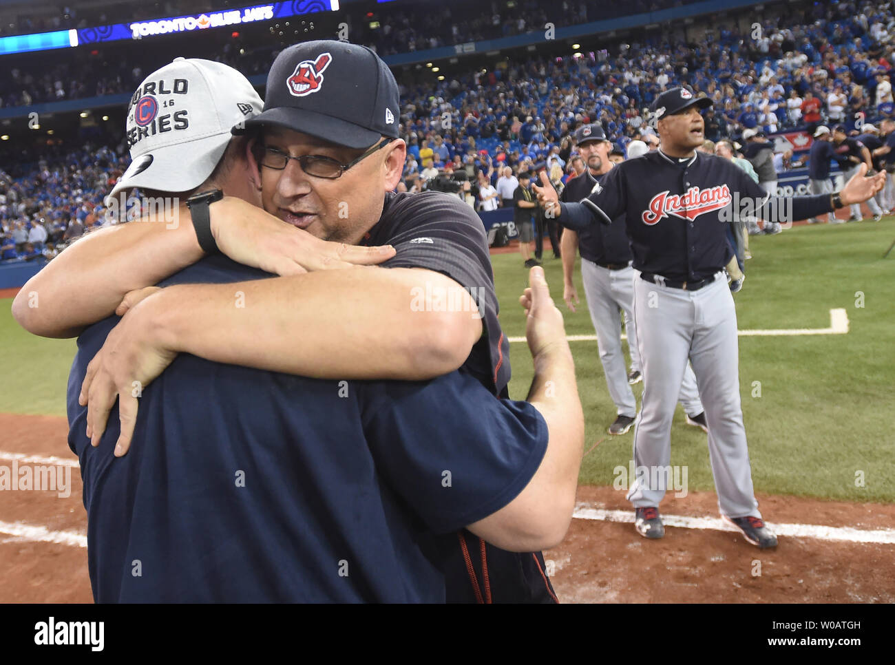 Cleveland Indians manager Terry Francona (L) hugs Indians game five  starting pitcher Ryan Merritt after winning the American League  Championship Series at Rogers Centre on October 19, 2016. Cleveland  defeated Toronto 3-0