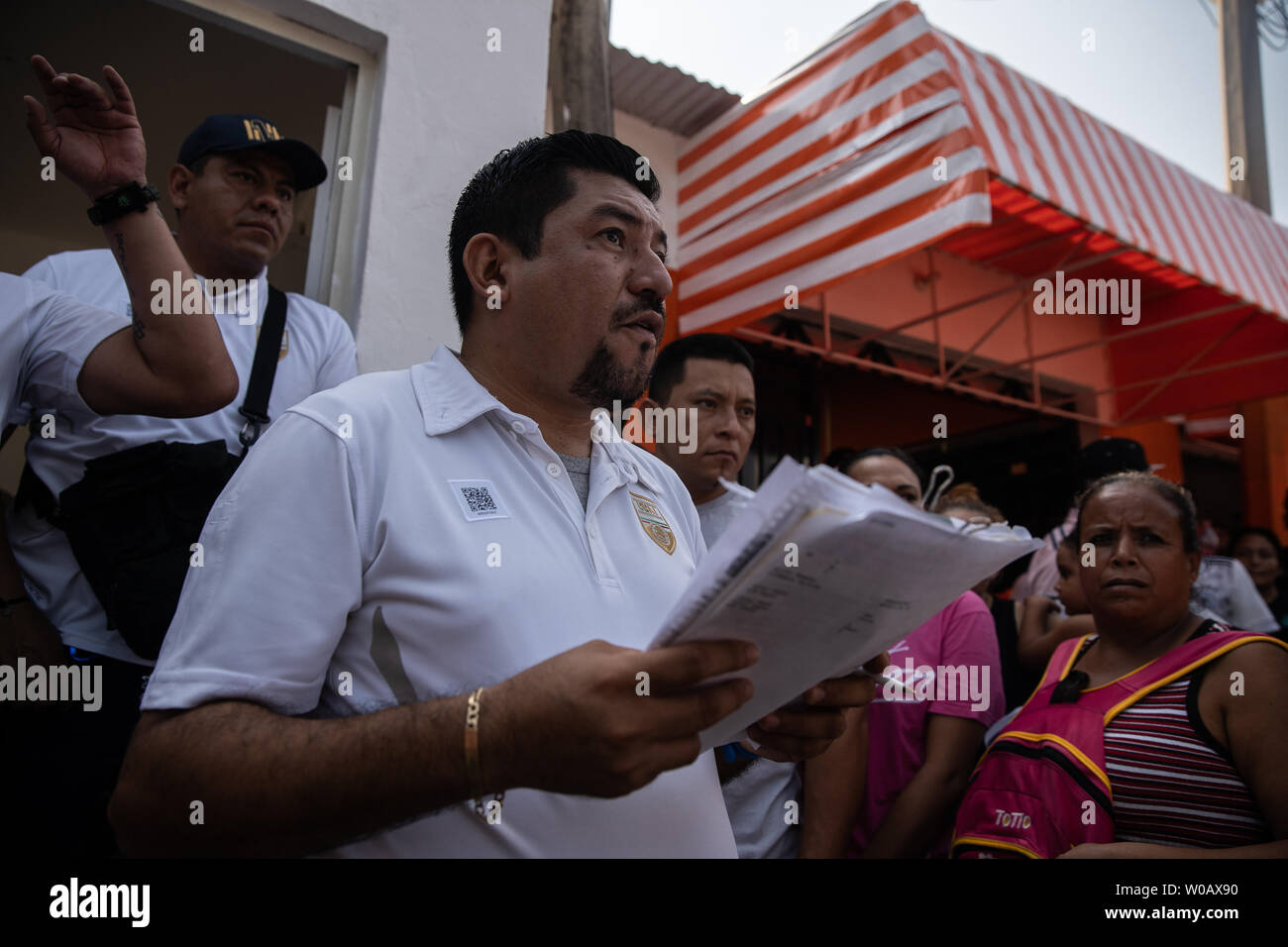 Javier Valdez holds a list of names in front of INM's Regional Sub-delegation office in Tapachula, Mexico on May 6, 2019.  Valdez calls the names of people so they can speak to someone about having the proper paperwork to be in Mexico.    Some migrants enter Mexico at this southern border town and then travel freely north to the United States border.     Photo by Ariana Drehsler/UPI Stock Photo