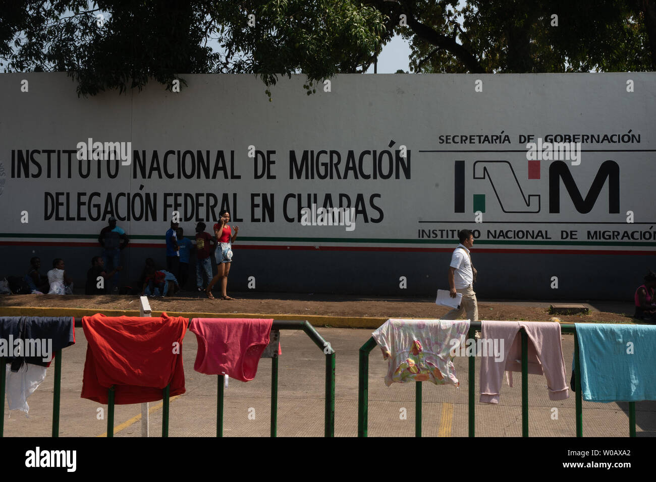 Migrants wait in front of (INM) Instituto Nacional de Migración Delegación  Federal en Chiapas in Tapachula, Mexico for their number to be called on  May 9, 2019. Once their number is called