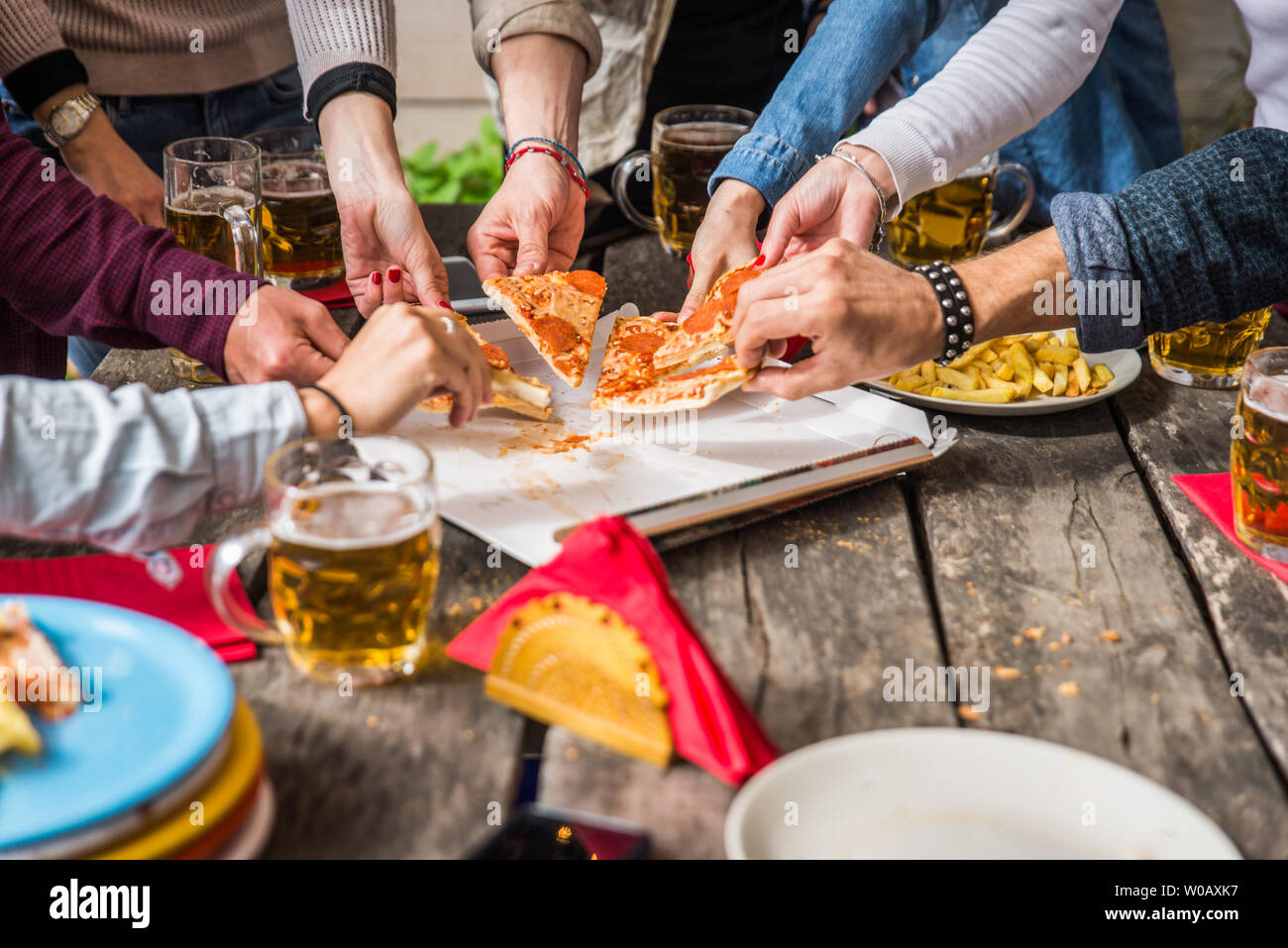 Group Of Happy Friends Bonding At Home Young Adults Having Lunch And Spending Time Together On A Rooftop Terrace Eating Pizza And Snacks Stock Photo Alamy