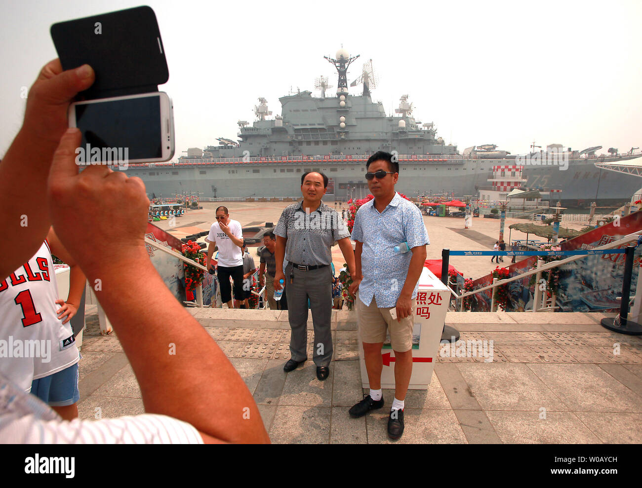 Chinese tourists visit the Binhai Aircraft Carrier Theme Park, featuring the ex-Russian heavy aircraft cruiser the Kiev, in Tianjin on July 29, 2014.  The Kiev was a heavy aircraft-carrying cruiser that served the Soviet and Russian navies from 1975 to 1993 before being sold to a Chinese company in 1996 for use in a military theme park.  Over $15.5 million was spent restoring and outfitting the ex-warship into a luxury hotel developed by tourism and attraction consultant Leisure Quest International (USA).      UPI/Stephen Shaver Stock Photo