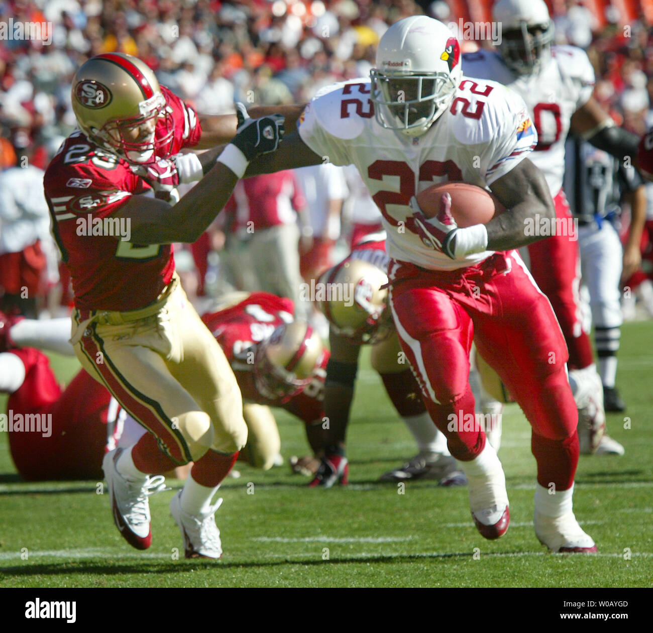 Phoenix Cardinals Emmitt Smith (22) puts a straight arm on San Francisco 49ers Ahmed Plummer (29) enroute to a TD at Monster Park in San Francisco on October 10, 2004.    (UPI Photo/Bruce Gordon) Stock Photo