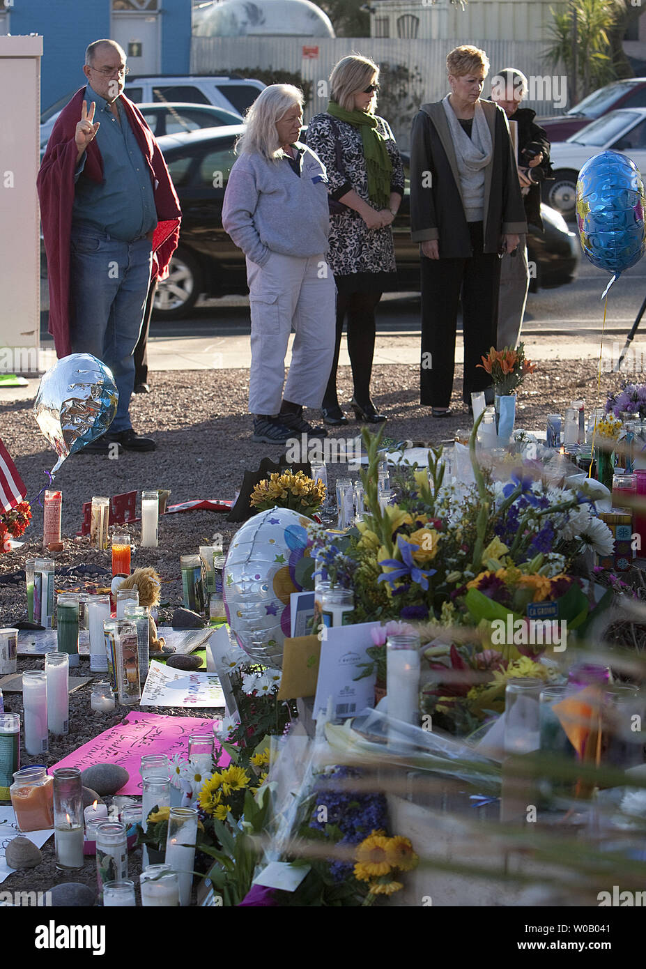 Outside the offices of U.S. Rep. Gabrielle Giffords mouirners observe a national moment of silence at 9 A.M. MDT two days after a young gunman shot and killed six people incuding U.S District Judge John Roll and critically wounded U.S Representative Gabrielle Giffords in Florence, Arizona on January 9, 2011.    The assassination attempt occurred near a northern Safeway in Tucson on January 8, 2011.       UPI/Gary C. Caskey Stock Photo