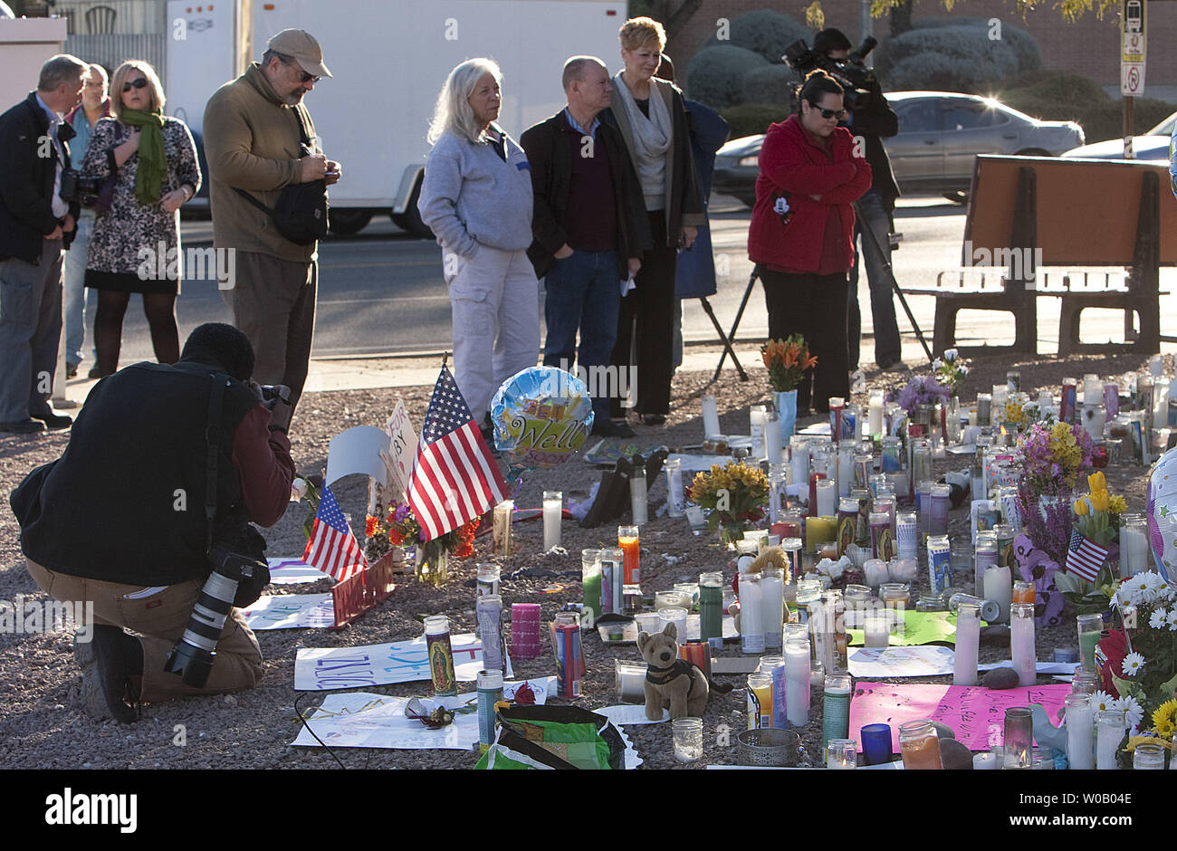 Mourners observe a national moment of silence at 9 A.M. MDT two days after a young gunman shot and killed six people incuding U.S District Judge John Roll and critically wounded U.S Representative Gabrielle Giffords in Florence, Arizona on January 9, 2011.    The assassination attempt occurred near a northern Safeway in Tucson on January 8, 2011.       UPI/Gary C. Caskey Stock Photo