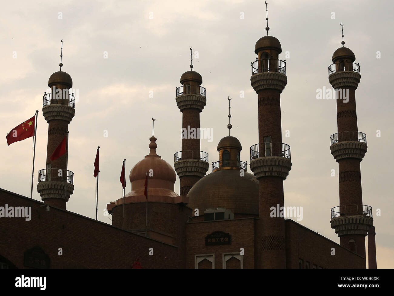 China's national flag flies over the mosque at the Grand Bazaar during Ramadan in what many consider the Muslim capital of China, Urumqi, the capital of China's predominantly Muslim and restive Xinjiang Province, on June 27, 2015.  Urumqi has been the sight of several bloody riots between the Chinese Han and the Muslim Uyghurs, prompting government officials to restrict movements and communications within the city, as well as travel outside the province.       Photo by Stephen Shaver/UPI Stock Photo