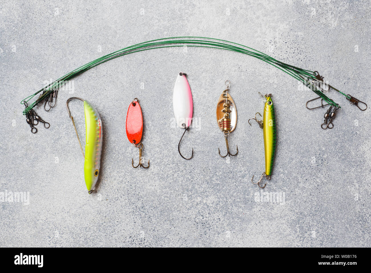 https://c8.alamy.com/comp/W0B176/fishing-hooks-and-baits-in-a-set-for-catching-different-fish-on-a-grey-background-with-copy-space-flat-lay-W0B176.jpg