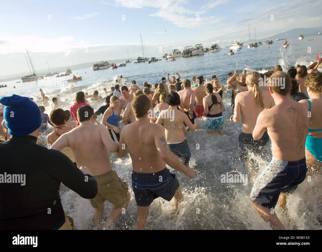 Some two thousand New Years Day revelers brave the frigid waters of downtown Vancouver's English Bay during the 85th Annual Polar Bear Swim, January 1, 2005.    (UPI Photo / Heinz Ruckemann) Stock Photo