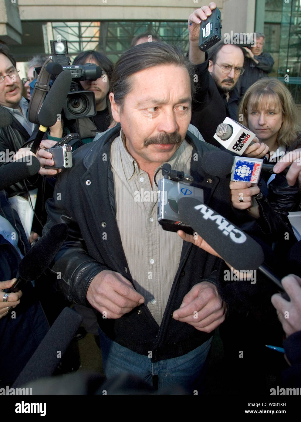 Fighting extradition on a 30-year-old murder charge one time American  Indian Movement (AIM) activist John Graham from the Yukon, is swarmed by  media as he leaves B.C. Supreme Court in Vancouver accompanied