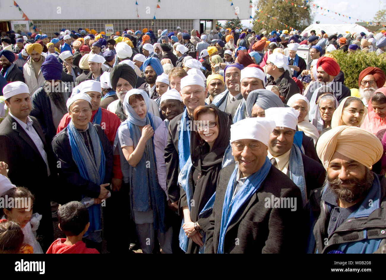 British Columbia (B.C.) Liberal Premier, Gordon Campbell (front center with wire rim glasses) stands behind star candidate Carol Taylor (dark rimmed glasses and black headcover), who recently resigned as chairperson of the Canadian Broadcast Corporation (CBC) to run in the Vancouver-Langara riding during the upcoming provincial election. Both Campbell and Taylor join tens of thousands of Sikhs waiting for the start of the Visakhi Parade from Vancouver's Ross Street Temple, April 16, 2005. One of the largest celebrations of it's kind in North America, Visakhi is the festival of harvest after wi Stock Photo