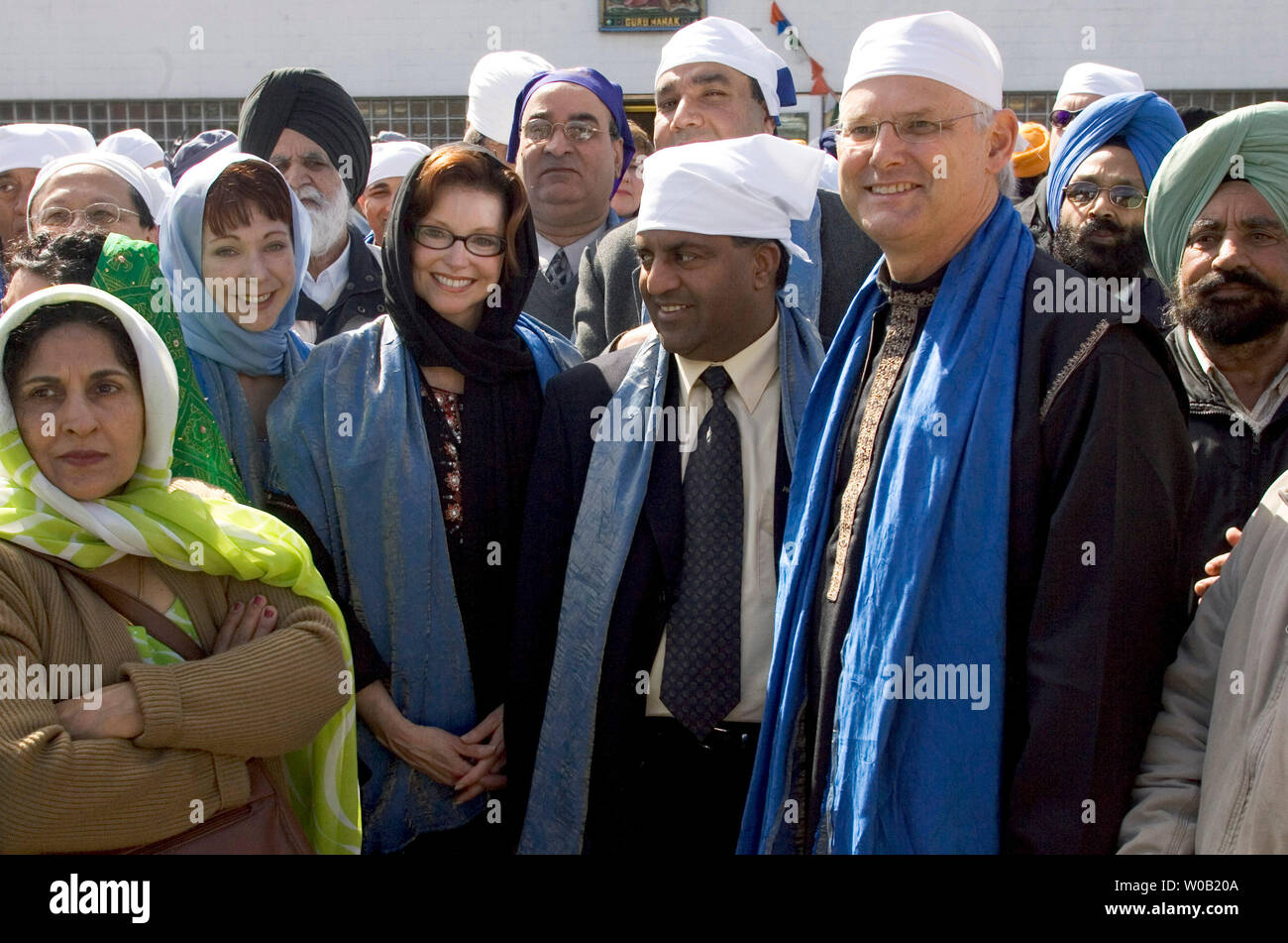 British Columbia (B.C.) Liberal Premier, Gordon Campbell (front with wire rim glasses)stands with star candidate Carol Taylor (front with dark rimmed glasses and black headcover), who recently resigned as chairperson of the Canadian Broadcast Corporation (CBC) to run in the Vancouver-Langara riding during the upcoming provincial election. Both Campbell and Taylor join tens of thousands of Sikhs waiting for the start of the Visakhi Parade from Vancouver's Ross Street Temple, April 16, 2005. One of the largest celebrations of it's kind in North America, Visakhi is the festival of harvest after w Stock Photo