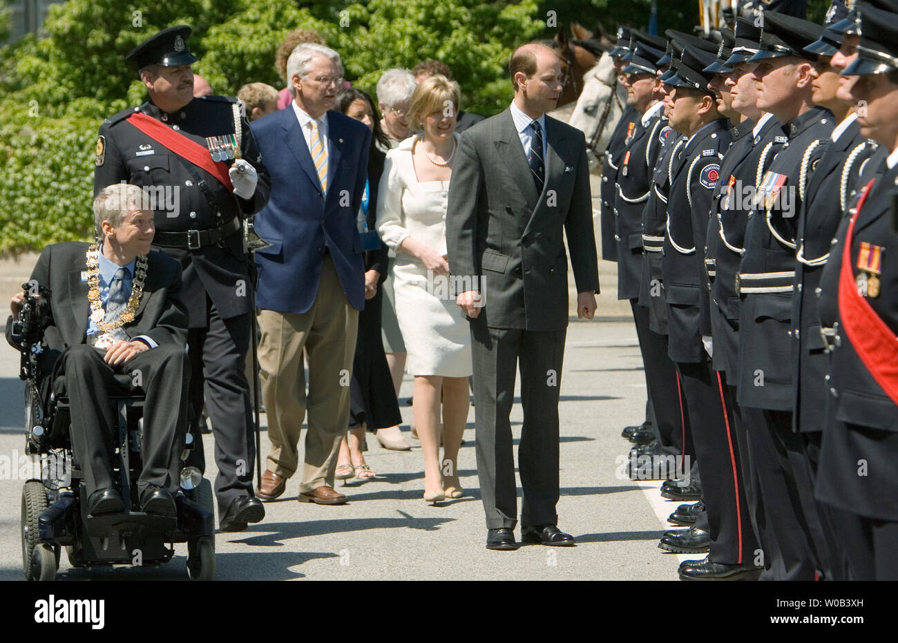 Accompanied by his wife Sophie, B.C. Premier Gordon Campbell (on Sophie's left) and Vancouver Mayor Sam Sullivan (in wheelchair), Prince Edward, Earl of Wessex, inspects the honor gaurd during a walkabout while visiting City Hall for the 2010 Paralympic Flag raising in Vancouver, British Columbia, June 7, 2006. (UPI Photo/Heinz Ruckemann) Stock Photo