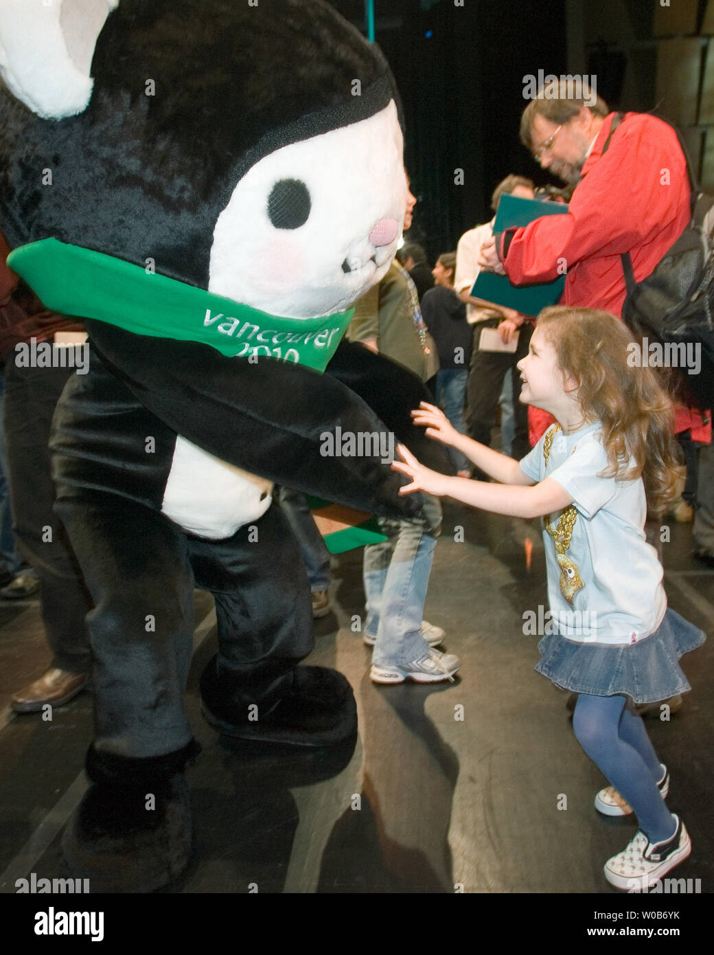 Four year old Dakota from Vancouver dances with Miga at the unveiling of the 2010 Winter Olympic Mascots Miga, Quatchi and Sumi in Surrey near Vancouver, British Columbia, November 27, 2007. Miga is a sea bear which according to First Nations legend is an orca whale which can turn into the rare white Kermode bear only found in British Columbia. Quatchi is a sasquatch described in many West Coast First Nations stories but rarely seen. Sumi is an animal gaurdian spirit who wears the hat of an orca, has the strong leags of the black bear and flies with the wings of the great thunderbird.  (UPI Ph Stock Photo