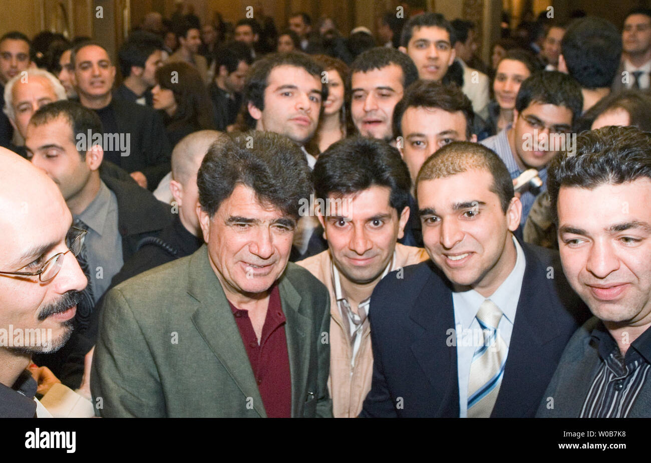 Iran's Mohammed Reza Shajarian (red shirt) a superstar of Persian classical music is mobbed by Iranian fans after his concert at the Orpheum Theater in Vancouver, British Columbia, May 4, 2008.    (UPI Photo/Heinz Ruckemann) Stock Photo