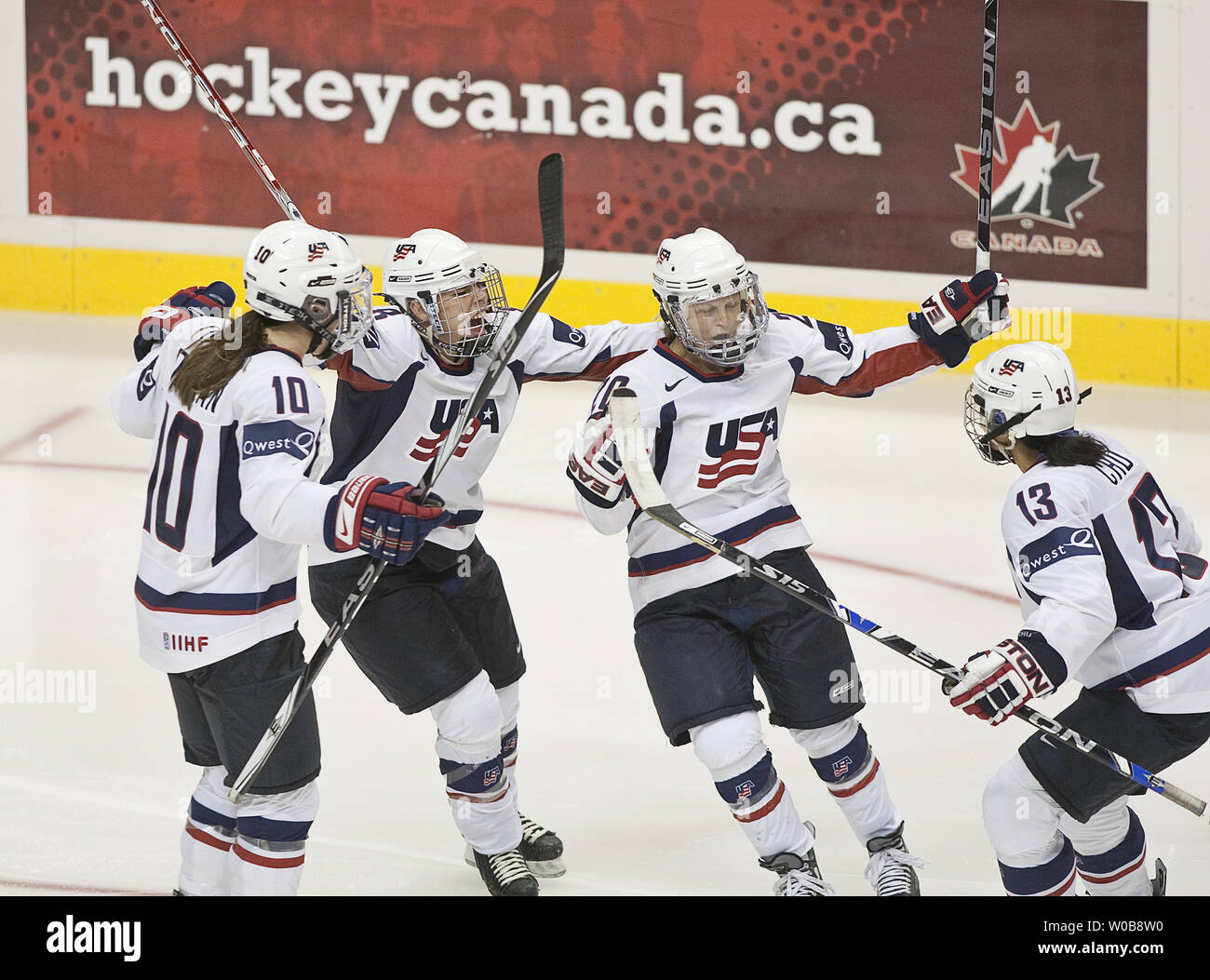 Team USA's Natalie Darwitz (Centre R.) celebrates scoring the winning goal against Team Canada with team mates Caitlin Cahow (Centre L.), Julie Chu (R) each with assists and Meghan Duggan during the third period of the Canada Cup Women's Hockey gold medal game at GM Place in Vancouver, British Columbia, September 6, 2009. Players have a chance to test the ice conditions at GM Place the main hockey venue for the 2010 Winter Olympics. UPI /Heinz Ruckemann Stock Photo