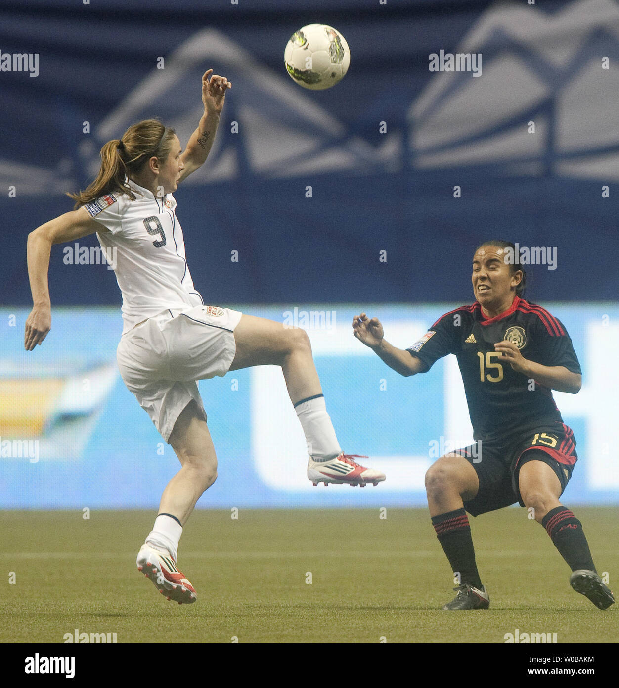 USA's Heather O'Reilly kicks the ball over Mexico's Rosario Saucedo
