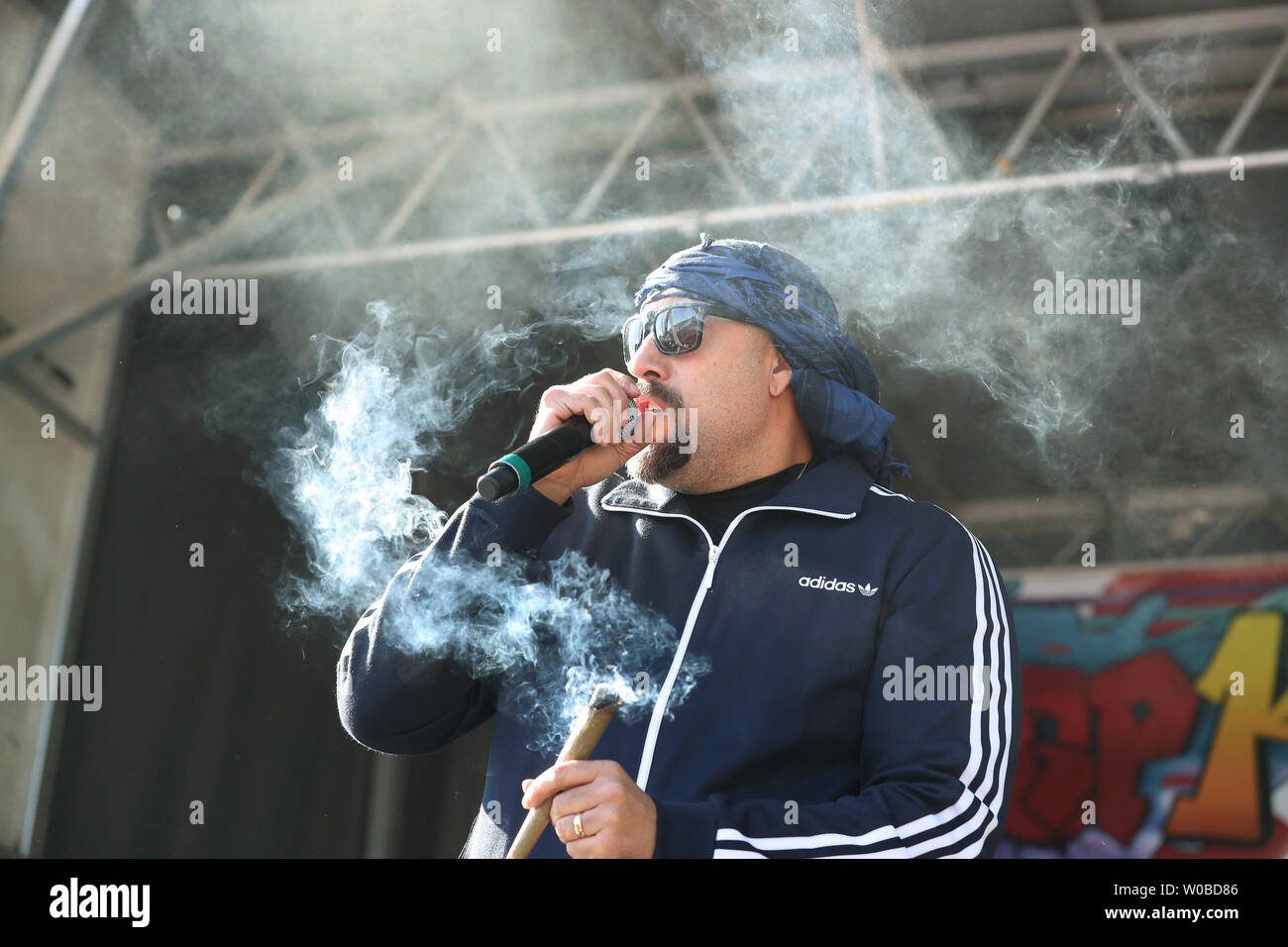 Louis "B-Real" Freese, of the Latino-American hip hop band Cypress Hill  smokes a joint onstage while performing during the controversial 25th  annual 4/20 protest at Sunset Beach in Vancouver, British Columbia on