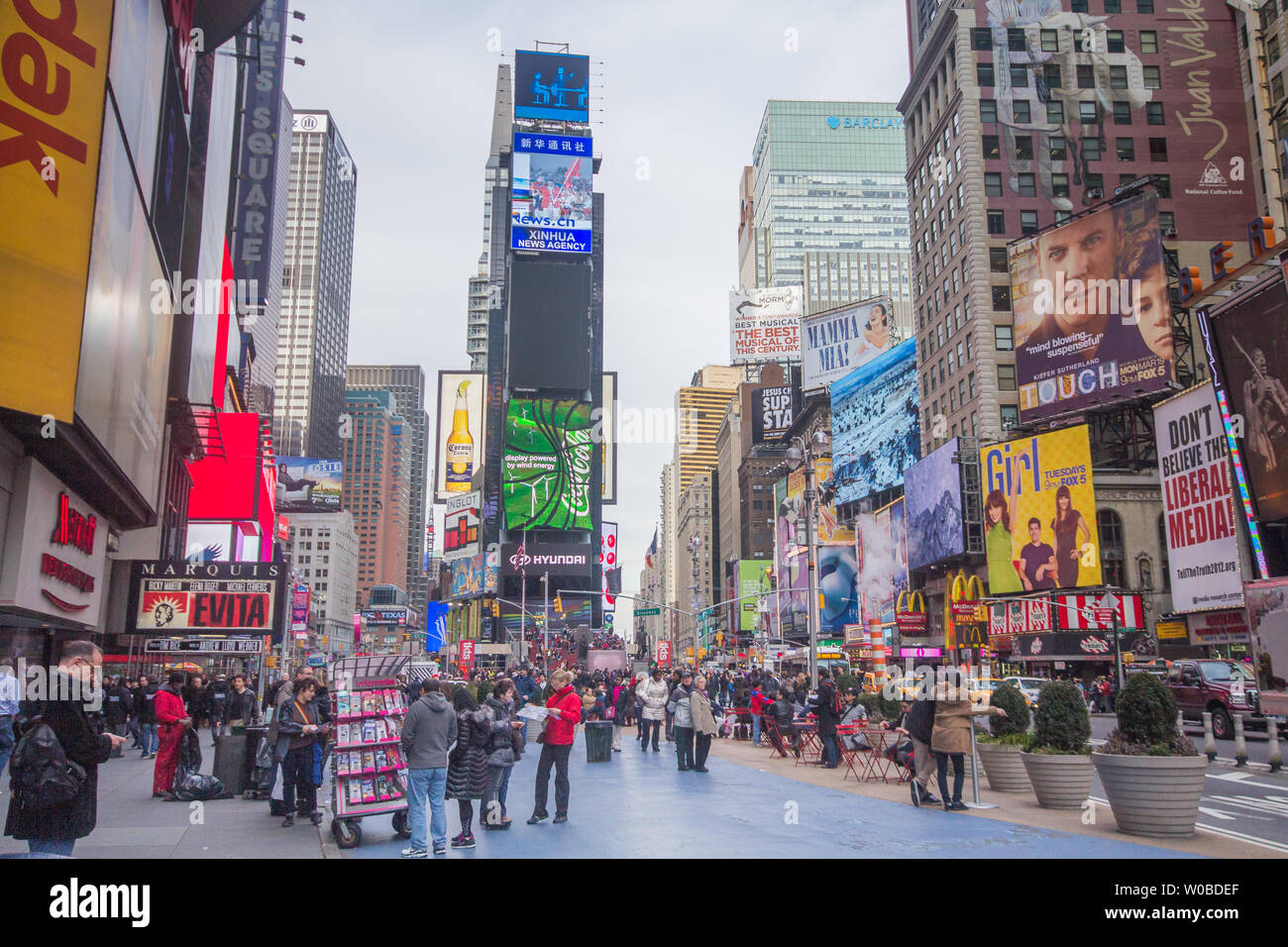 New York City, United States - February 22, 2012: street scene, with busy people walking, at the Times Square region of Manhattan, wide angle showing Stock Photo