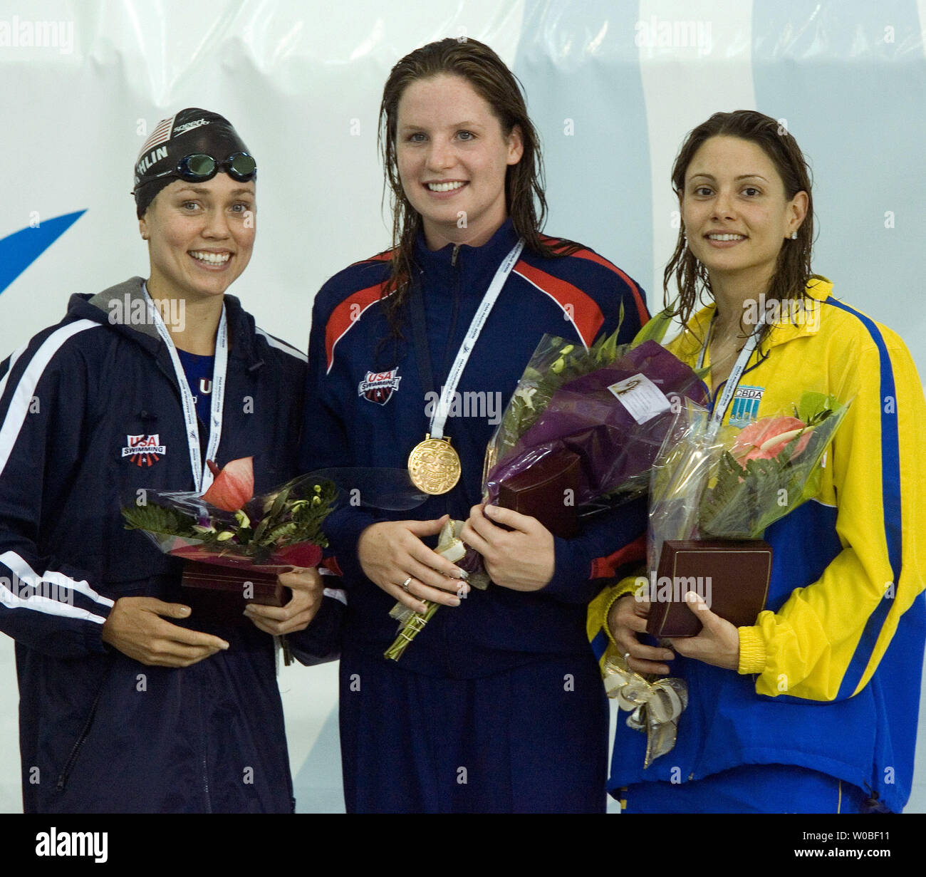 On the podium from left, Natalie Coughlin, USA, silver, Kara Lynn Joyce, USA, gold and Flavia Delaroli, BRA, bronze, receive their awards in the women's 500m freestyle swimming finals at the 2006 Pan Pacific Championships in Saanich Commonwealth Place, Victoria, British Columbia, August 20, 2006.  (UPI Photo/Heinz Ruckemann) Stock Photo