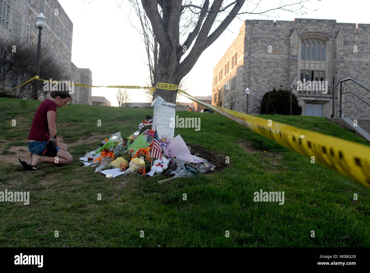 A young woman visits a memorial in front of Norris Hall, on the campus of Virginia Tech in Blacksburg, Virginia on April 22, 2007. Cho Seung-Hui, a student at Virginia Tech, went on a shooting spree and murdered 32 people on April 16, 2007, the deadliest school shooting in U.S. history. (UPI Photo/Kevin Dietsch) Stock Photo