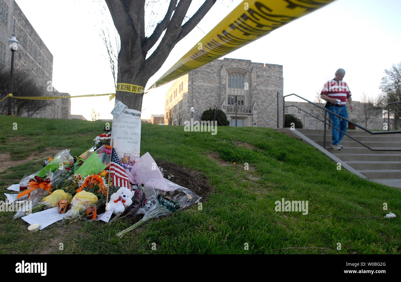 A police officer walks past a memorial in front of Norris Hall, on the campus of Virginia Tech in Blacksburg, Virginia on April 22, 2007. Cho Seung-Hui, a student at Virginia Tech, went on a shooting spree and murdered 32 people on April 16, 2007, the deadliest school shooting in U.S. history. (UPI Photo/Kevin Dietsch) Stock Photo