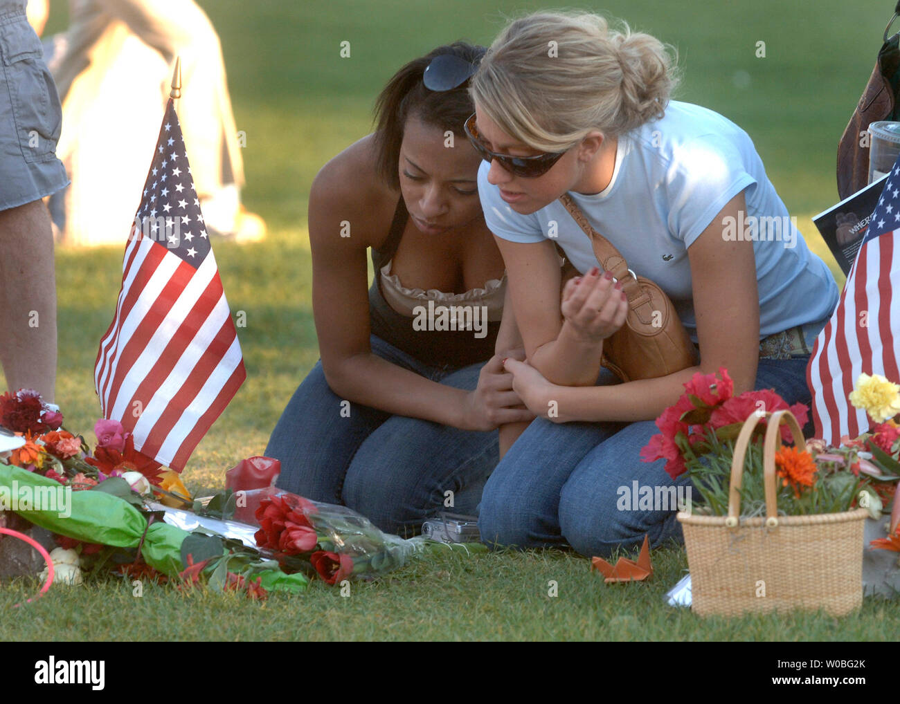 Young women visit a memorial on Drill Field, on the campus of Virginia Tech in Blacksburg, Virginia on April 22, 2007. Cho Seung-Hui, a student at Virginia Tech, went on a shooting spree and murdered 32 people on April 16, 2007. It was the deadliest school shooting in U.S. history. (UPI Photo/Kevin Dietsch) Stock Photo