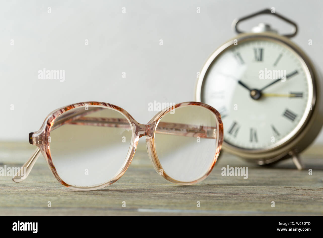 glasses and alarm clock Stock Photo - Alamy