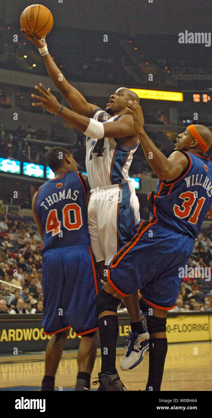 Jarvis Hayes of the Washington Wizards scores 2 of his 8 points and is  fouled by Kurt Thomas of the New York Knicks in the Wizards 106 - 104 win  on December