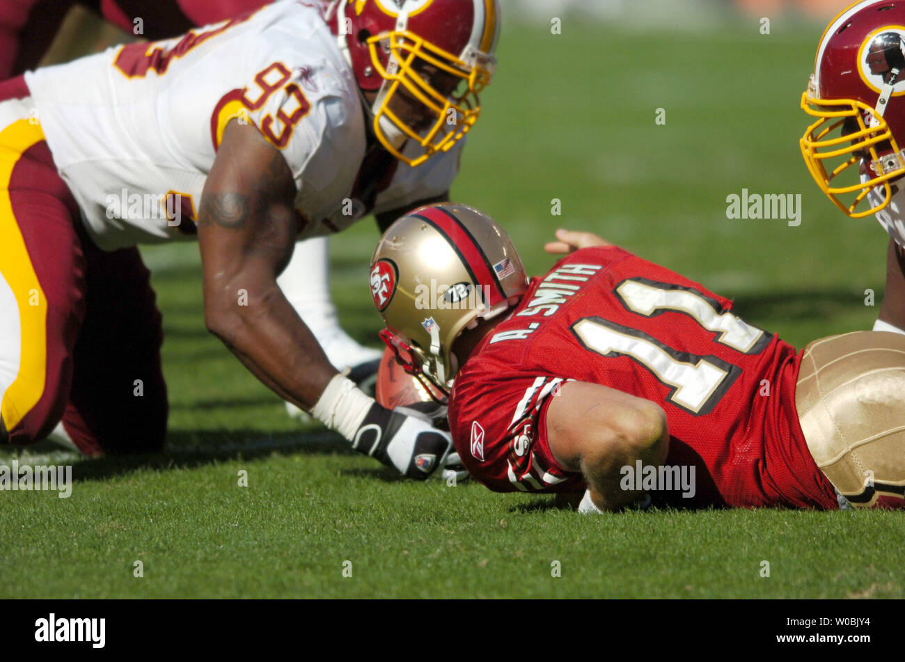 Washington Redskins defenders Sean Taylor (21) Phillip Daniels (93) and  Khary Campbell (50) stop Indianpolis Colts