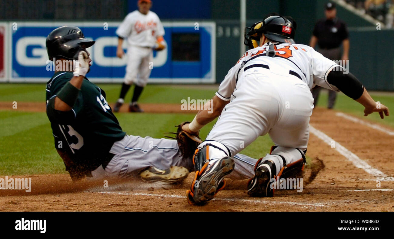 The Tampa Bay Devil Rays Carl Crawford is tagged out at home in