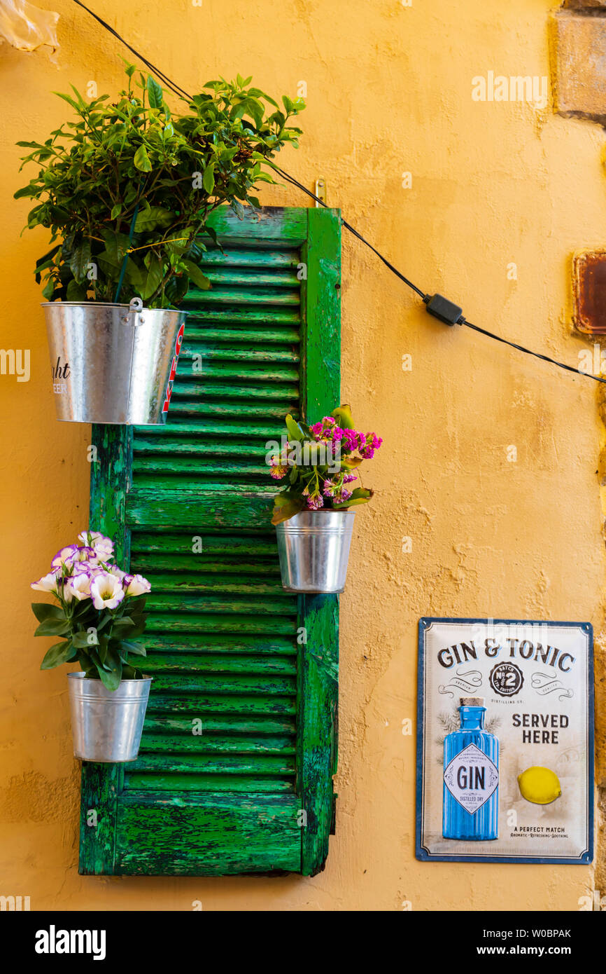 Colourful, painted shutters with pot plants, Larnaca, Cyprus. June 2019 Stock Photo