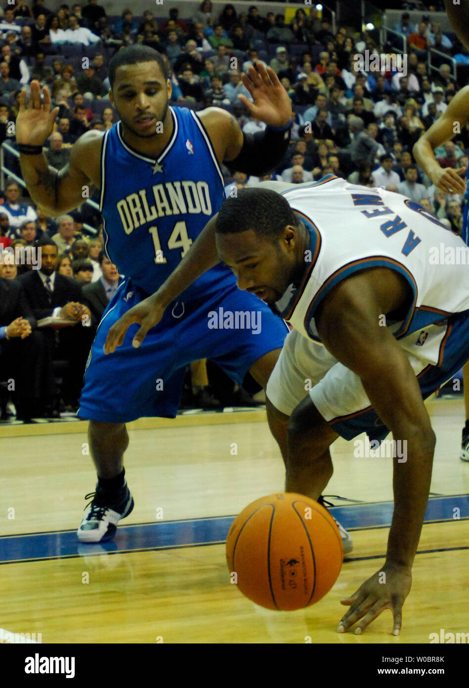 The Washington Wizards guard Gilbert Arenas dives for a loose ball in the first half against the Orlando Magic's Jameer Nelson (14) on December 29, 2006 at Verizon Center in Washington, D.C.  (UPI Photo/ Mark Goldman) Stock Photo