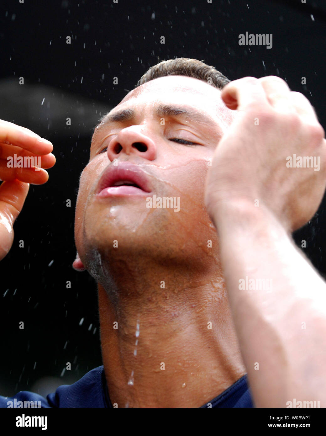 New York Yankees third baseman Alex Rodriguez splashes water on his