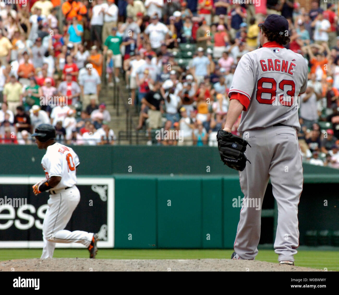 Boston Red Sox pitcher Eric Gagne (83) stands on the mound after giving up  a two run home run to Baltimore Orioles shortstop Miguel Tejada (10) who  circles the bases in the