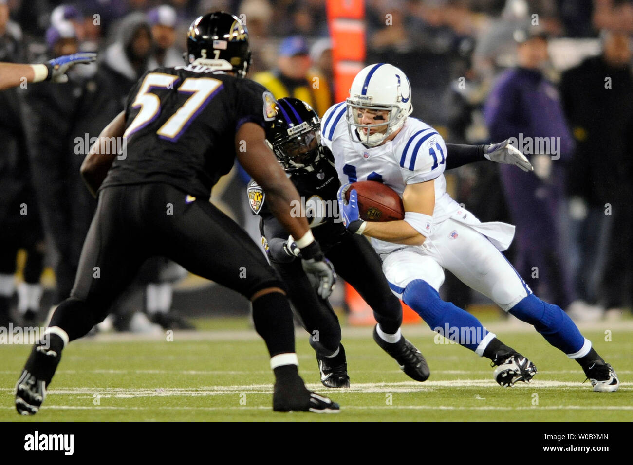 Indianapolis Colts wide receiver Anthony Gonzalez (11) catches a pass for a 15-yard gain in the first quarter before being tackled by Baltimore Ravens safety Dawan Landry (L) on December 9, 2007 at M&T Bank Stadium in Baltimore, Maryland.  (UPI Photo/ Mark Goldman) Stock Photo