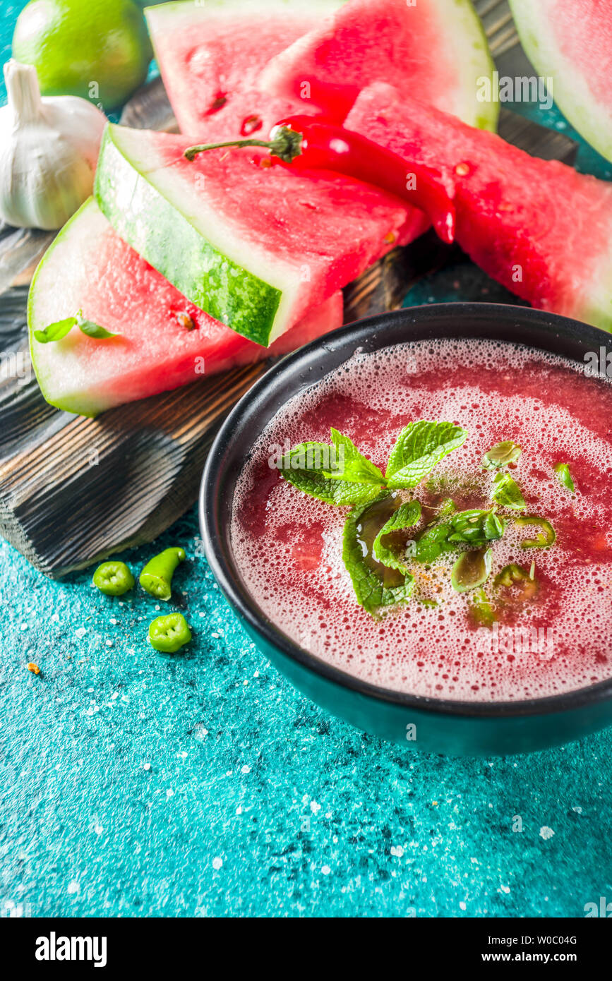 Summer cold watermelon smoothie gazpacho soup, marine blue background ...