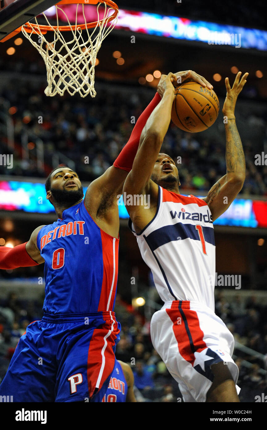 Washington Wizards small forward Trevor Ariza (1) scores and is fouled by Detroit Pistons center Andre Drummond (0) in the first half at the Verizon Center in Washington, D.C. on December 28, 2013.   UPI/Mark Goldman Stock Photo