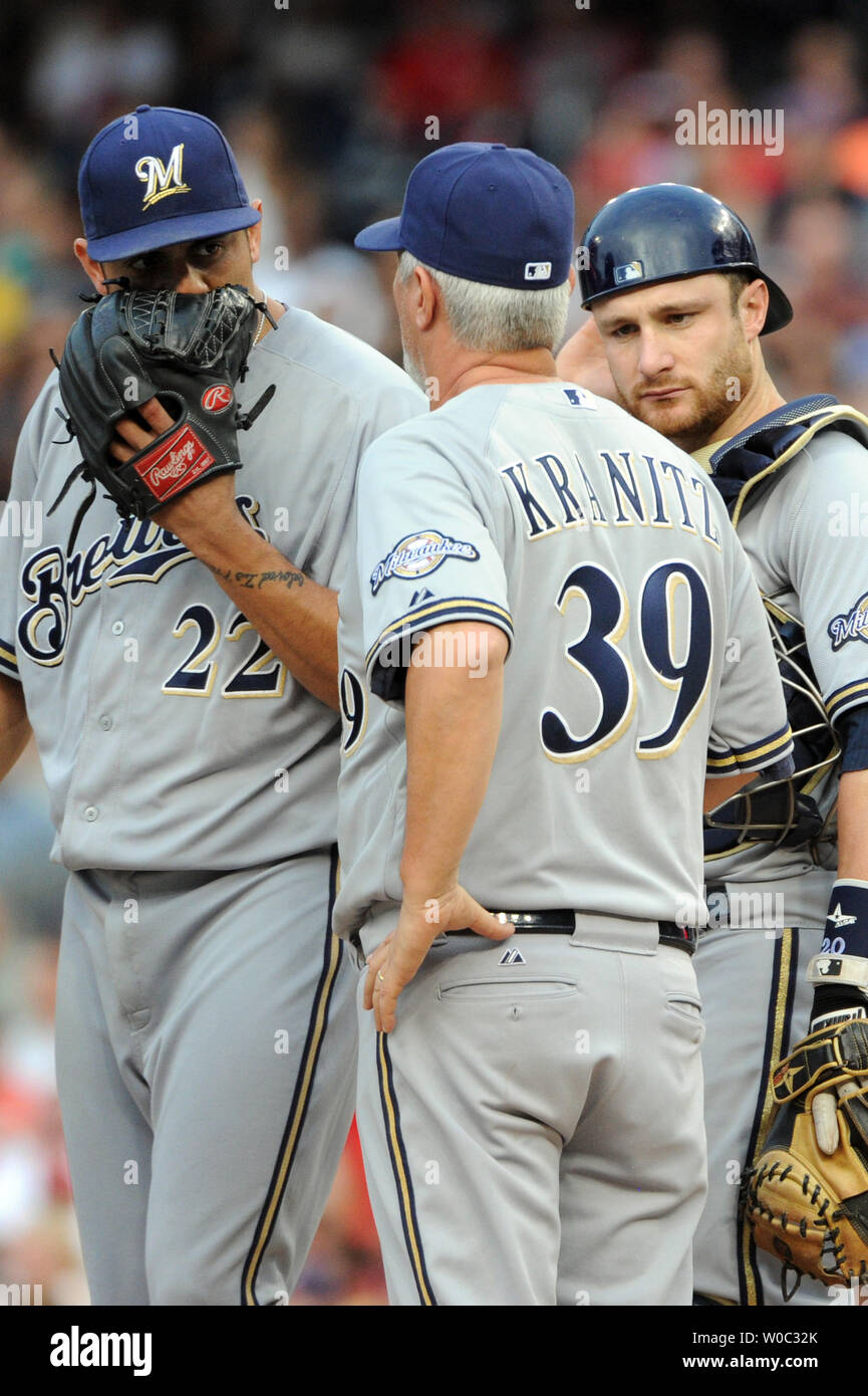 Atlanta Braves pitching coach Rick Kranitz hands out cigars after