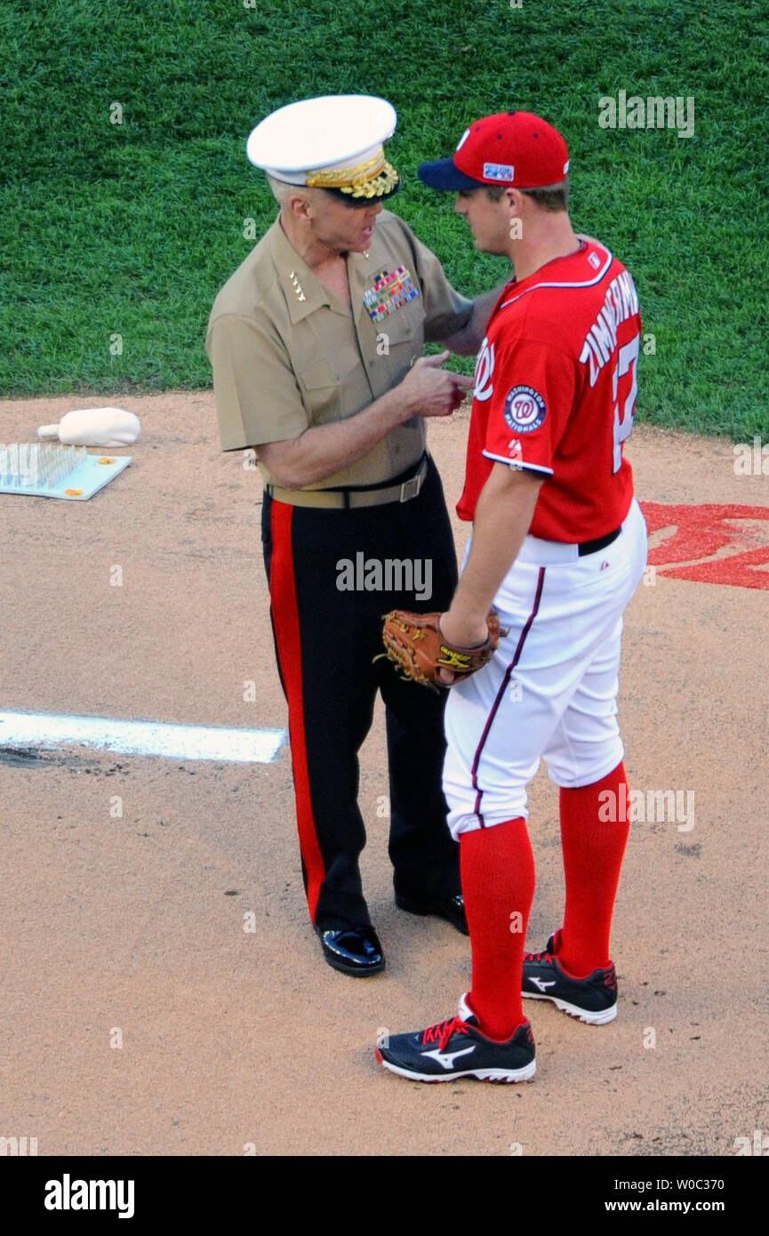 Four-star Gen. James Amos, commandant of the Marine Corps delivers the ball to Washington Nationals starting pitcher Jordan Zimmermann (27) for game 2 of the National League Division Series at Nationals Park in Washington, D.C. on October 4, 2014.   UPI/Mark Goldman Stock Photo