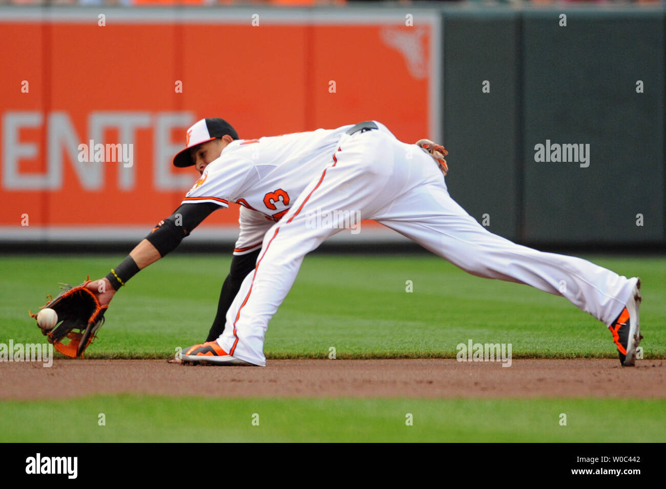 Baltimore Orioles third baseman Manny Machado (13) makes a diving stop on a  ground ball against the Boston Red Sox in the first inning at Orioles Park  at Camden Yards in Baltimore