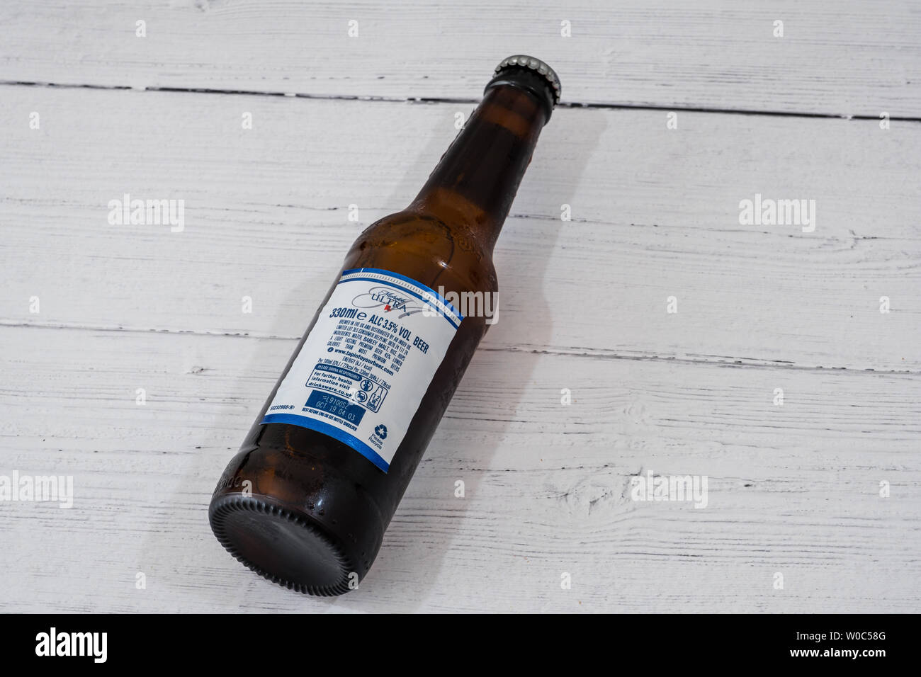 Largs, Scotland, UK - June 20, 2019: A Bottle of Michelob Ultra branded Lager Beer in recyclable glass bottle in line with current UK initiatives rear Stock Photo