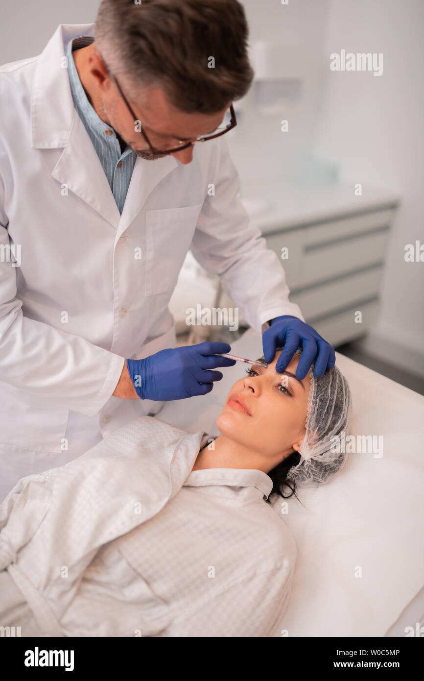 Doctor making injection anti hi-res stock photography and images - Alamy
